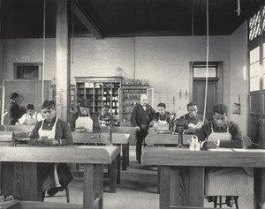 Class in manual training Bent iron and tin